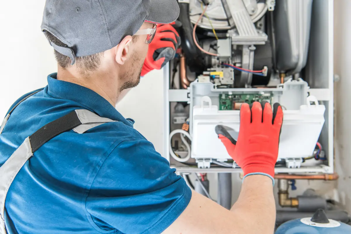 HVAC technician performing annual maintenance on a boiler in North York